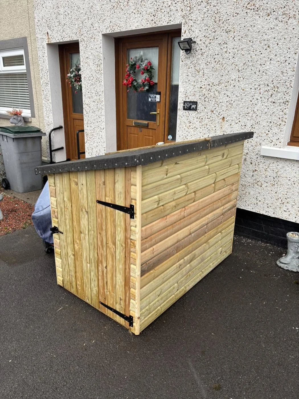 Compact timber outdoor storage unit with a hinged door