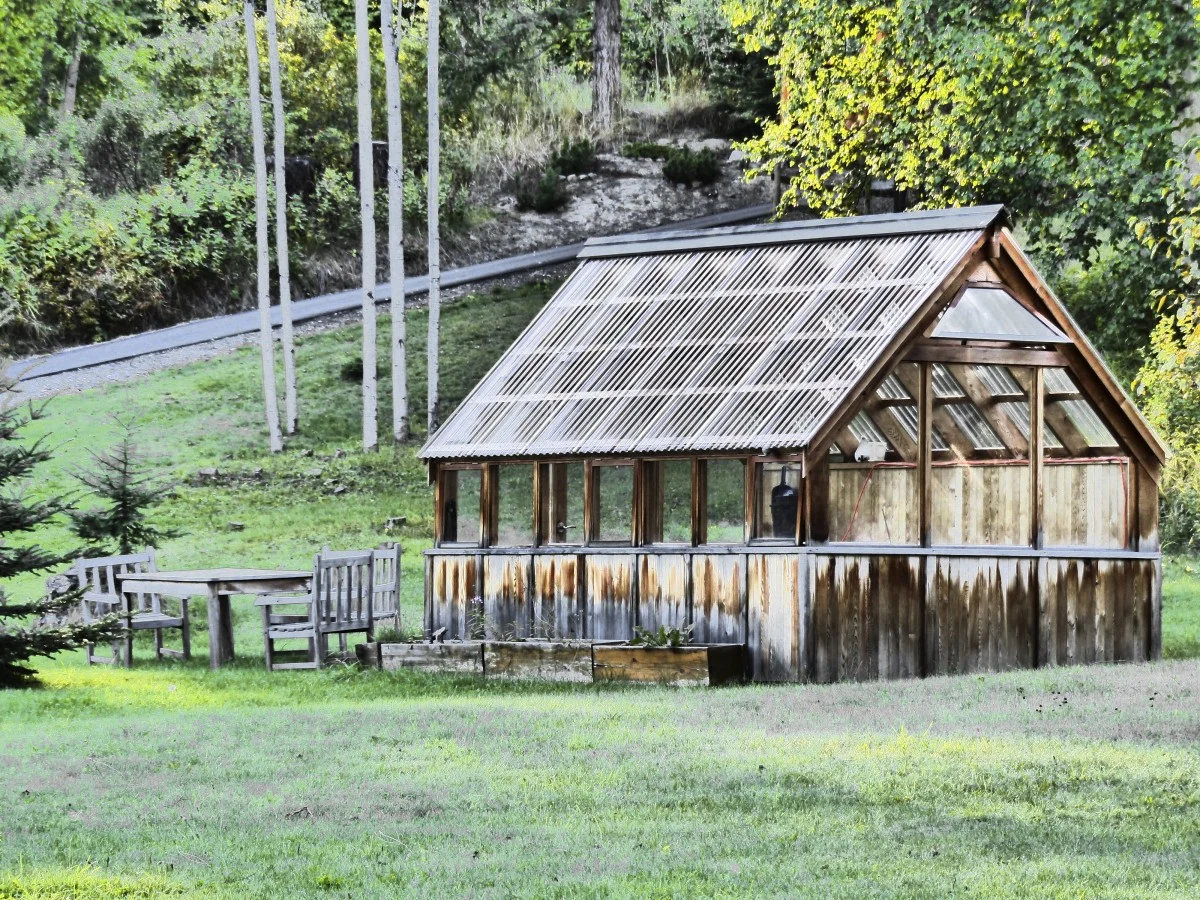 Stock example of a timber garden summerhouse in a green garden