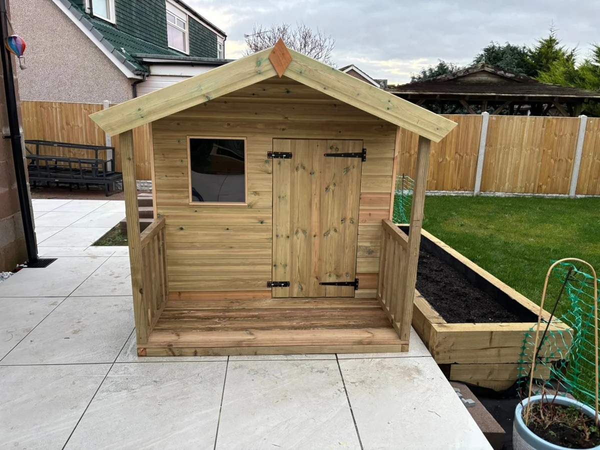 LC Fencing & Sheds timber children’s playhouse with an apex roof, front window and covered veranda